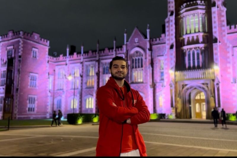 Ahmed Wisam student standing across from Lanyon building at Queen's University Belfast